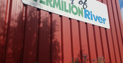 County of Vermilion Sign on red building